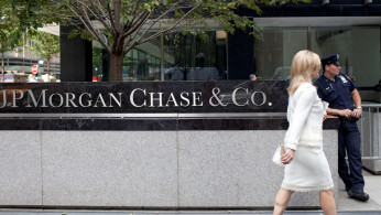 A woman walks past JPMorgan Chase & Co's international headquarters on Park Avenue in New York.