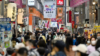 FILE PHOTO: Pedestrians wearing protective face masks, amid the coronavirus disease (COVID-19) pandemic