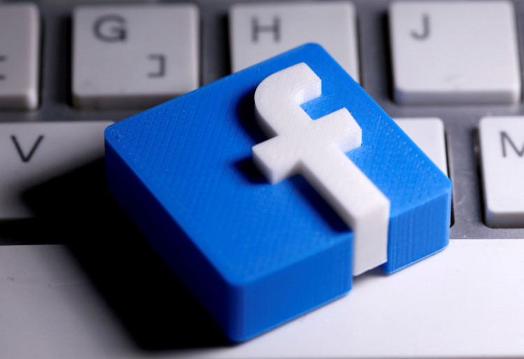 A 3D-printed Facebook logo is seen placed on a keyboard.