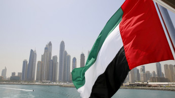 FILE PHOTO: UAE flag flies over a boat at Dubai Marina, Dubai, United Arab Emirates May 22, 2015. 