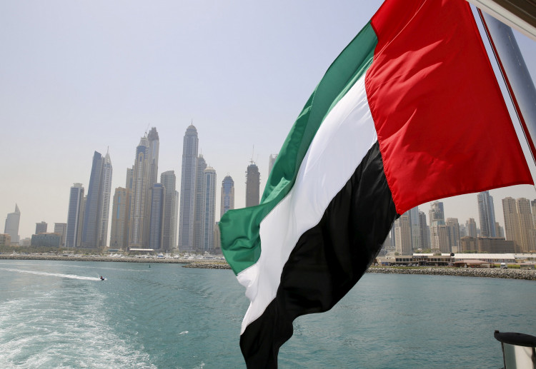 FILE PHOTO: UAE flag flies over a boat at Dubai Marina, Dubai, United Arab Emirates May 22, 2015. 