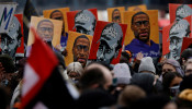 People hold placards after the verdict in the trial of former Minneapolis police officer Derek Chauvin.