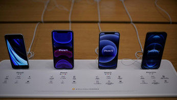 Apple's 5G iPhone 12 and iPhone 11 are seen at an Apple Store.