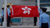 Police officers fold Chinese and Hong Kong flags at a flag-lowering ceremony on the Golden Bauhinia Square in Hong Kong, China March 30, 2021. 