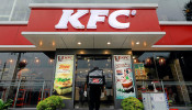 FILE PHOTO: A delivery staff member wearing a protective mask enters a KFC fast food outlet after a delivery in Colombo
