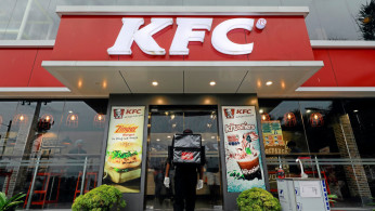 FILE PHOTO: A delivery staff member wearing a protective mask enters a KFC fast food outlet after a delivery in Colombo