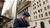  A man walks past the New York Stock Exchange on the corner of Wall and Broad streets in New York City.