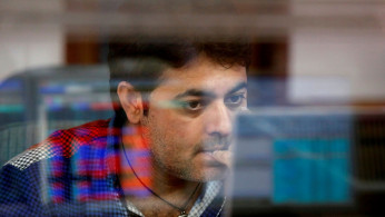A broker reacts while trading at his computer terminal at a stock brokerage firm in Mumbai, India.