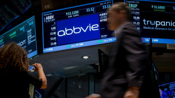A screen displays the share price for pharmaceutical maker AbbVie on the floor of the New York Stock Exchange.