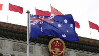 FILE PHOTO: Australian flag flutters in front of the Great Hall of the People during a welcoming ceremony for Australian Prime Minister Malcolm Turnbull (not in picture) in Beijing, China, April 14, 2016. 