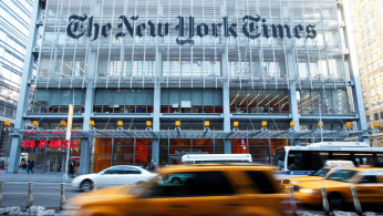 FILE PHOTO: Vehicles drive past the New York Times headquarters in New York March 1, 2010. 