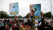 People take part in a protest supporting Rizieq Shihab, an Indonesian Islamic cleric who is sentenced for breaching coronavirus disease (COVID-19) guidelines. 