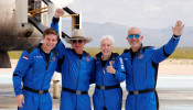 Billionaire American businessman Jeff Bezos (2nd-L) poses for pictures with crew mates