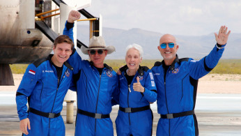 Billionaire American businessman Jeff Bezos (2nd-L) poses for pictures with crew mates