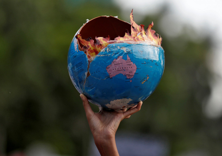 A replica depicting globe on fire during a "Fridays for Future" march
