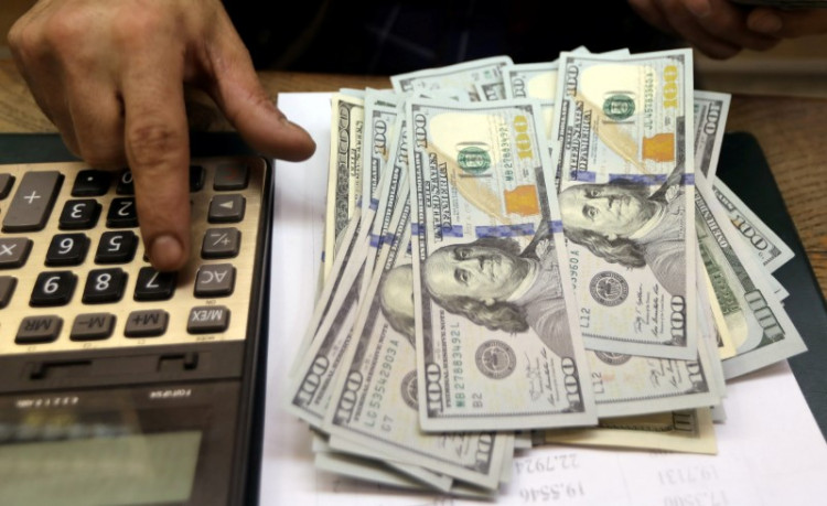 An employee counts U.S. dollar bills at a money exchange in central Cairo, Egypt, March 20, 2019.