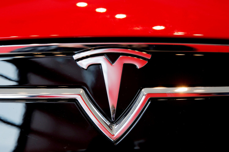 FILE PHOTO: A Tesla logo on a Model S is photographed inside of a Tesla dealership in New York, U.S., April 29, 2016. 
