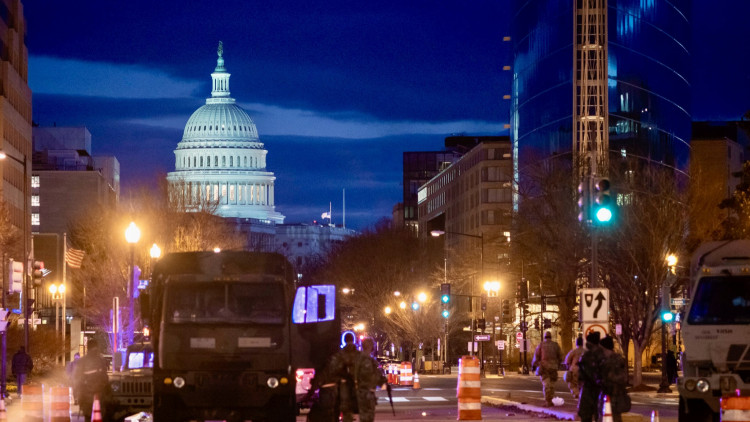 Capitol riot violence denial sparks firm response from Newsmax host during panel discussion.