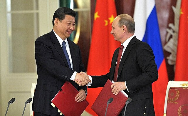China’s Xi Arrives in Moscow Amid Drone Strikes, Trade War, and Calls for U.S. 'De-Americanization'