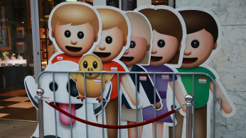 Life-size emojis on display during an iPhone launch