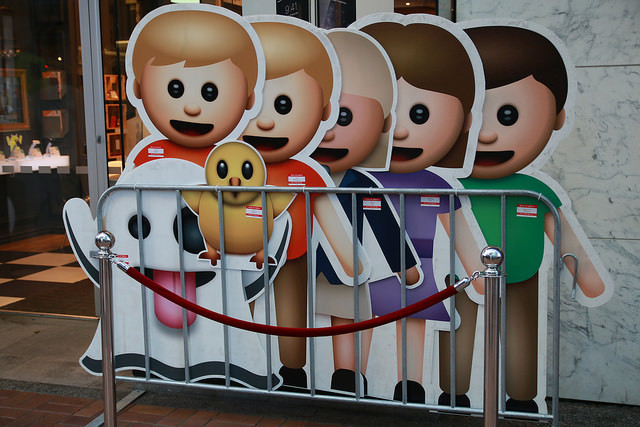 Life-size emojis on display during an iPhone launch