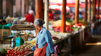 Old woman shopping in market