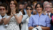 Britain's Catherine, the Duchess of Cambridge, and Meghan, the Duchess of Sussex, applaud after Germany's Angelique Kerber won the women's singles final against Serena Williams of the U.S. at Wimbledon in London