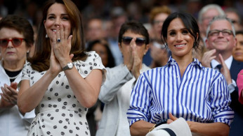 Britain's Catherine, the Duchess of Cambridge, and Meghan, the Duchess of Sussex, applaud after Germany's Angelique Kerber won the women's singles final against Serena Williams of the U.S. at Wimbledon in London
