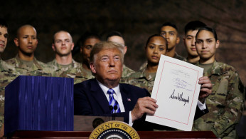 US president Donald Trump signs the National Defense bill