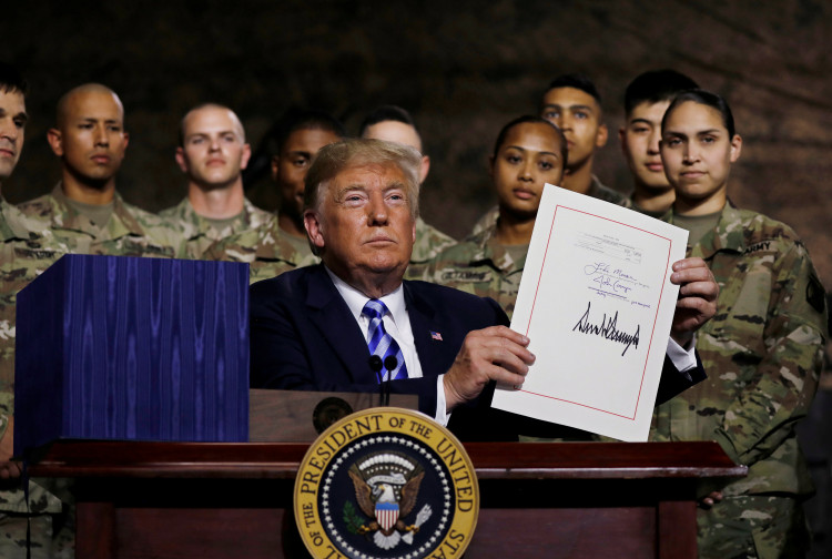 US president Donald Trump signs the National Defense bill