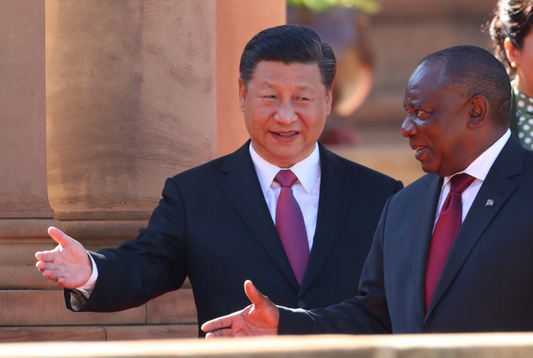 China's President Xi Jinping walks with South African President Cyril Ramaphosa before their meeting in Pretoria