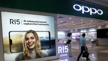 A man passes by an Oppo shop in Singapore