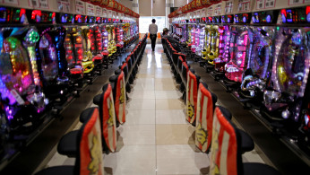 Visitors play pachinko, a Japanese form of legal gambling, at a pachinko parlour in Fukushima
