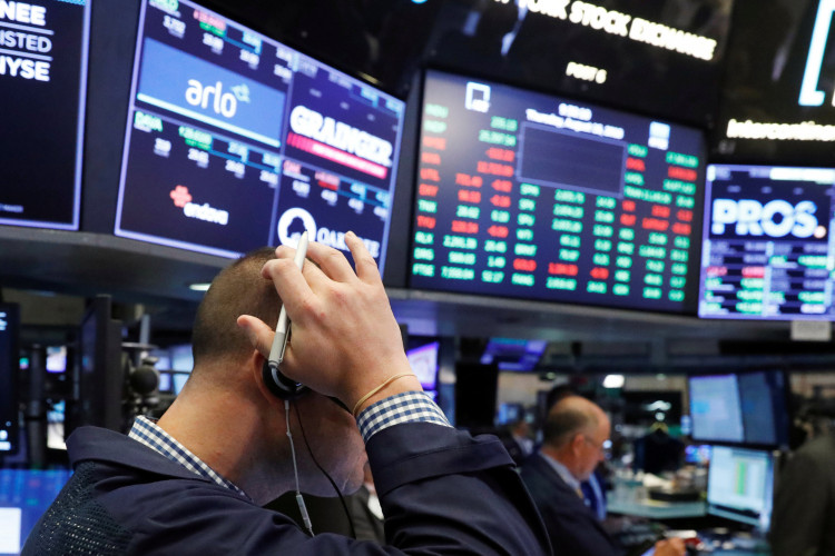A trader works on the floor of the New York Stock Exchange shortly after the opening bell in New York