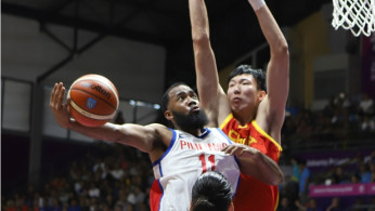 Stanley Pringle of team Philippines takes a shot against his Chinese defender during the 18th Asian Games Jakarta Palembang.