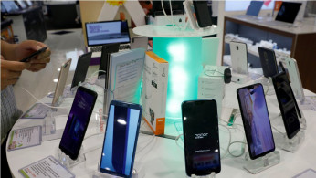 Chinese branded Honor and Vivo smartphones are displayed in a shop in Singapore