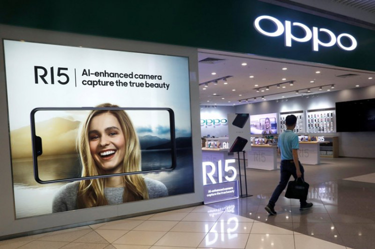 A man passes by an Oppo shop in Singapore