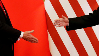 U.S. President Donald Trump and China's President Xi Jinping shake hands