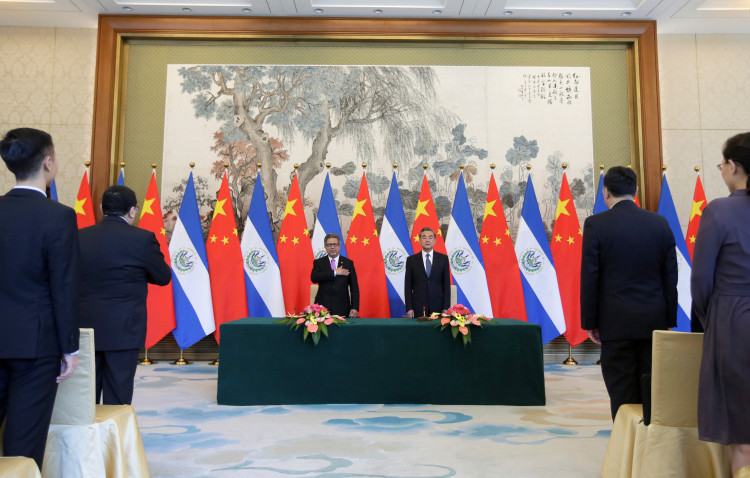 Chinese Foreign Minister Wang Yi and El Salvador's Foreign Minister Carlos Castaneda attend a signing ceremony to establish diplomatic ties between the two countries in Beijing