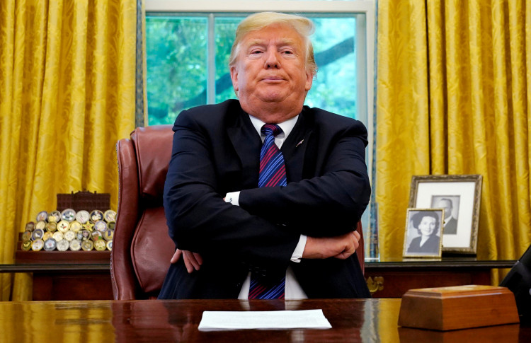 President Trump sits behind his desk as he makes announcement about a bilateral trade deal with Mexico