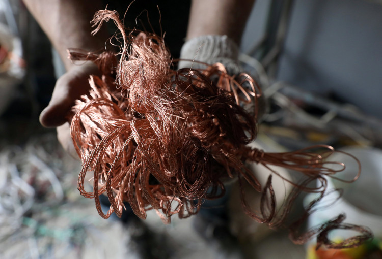 Man shows recycled copper cables at 'A Caminar' recycling plant in Lima
