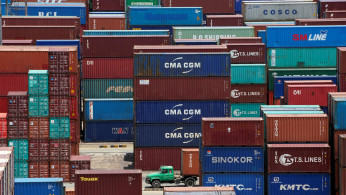 Shipping containers are seen at a port in Shanghai