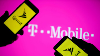 Sprint logo on phones in front of T-Mobile logo on screen