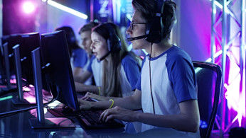 Team of Professional eSport Gamers Playing in Competitive Video Games on a Cyber Games Tournament 