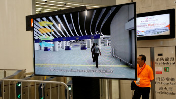 A video telling passengers to comply with mainland laws is displayed during the open day of West Kowloon Terminus in Hong Kong