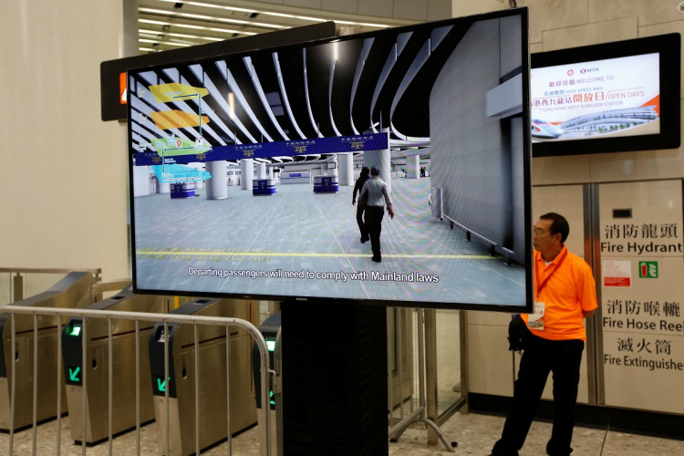 A video telling passengers to comply with mainland laws is displayed during the open day of West Kowloon Terminus in Hong Kong