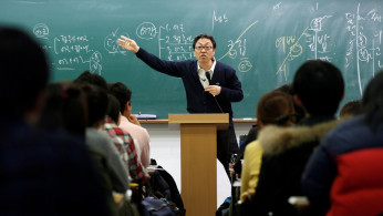 A teacher gives a lecture at a cram school in a Goshichon in Seoul