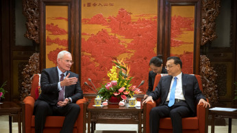 Exxon Mobil CEO Darren Woods and Chinese Premier Li Keqiang