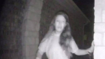 Security camera image of a partially dressed woman