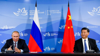 Russian President Putin and Chinese President Xi Jinping attend a meeting with participants of a round table discussion on Russia-China Cooperation